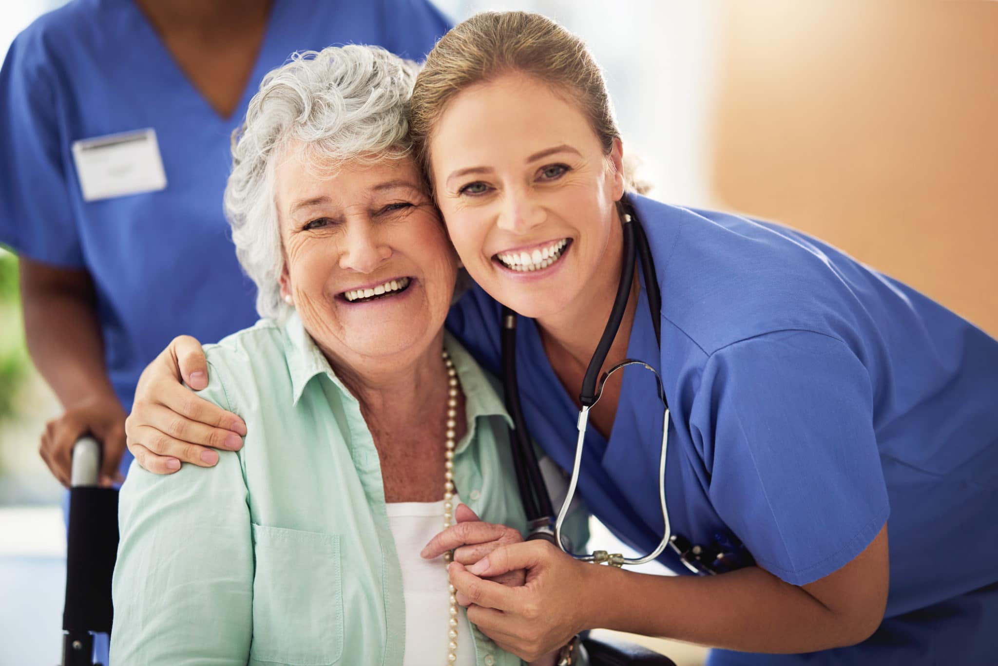 Portrait of a smiling nurse with her senior patient in a hospital