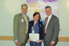 Nurse holding an award for being honored