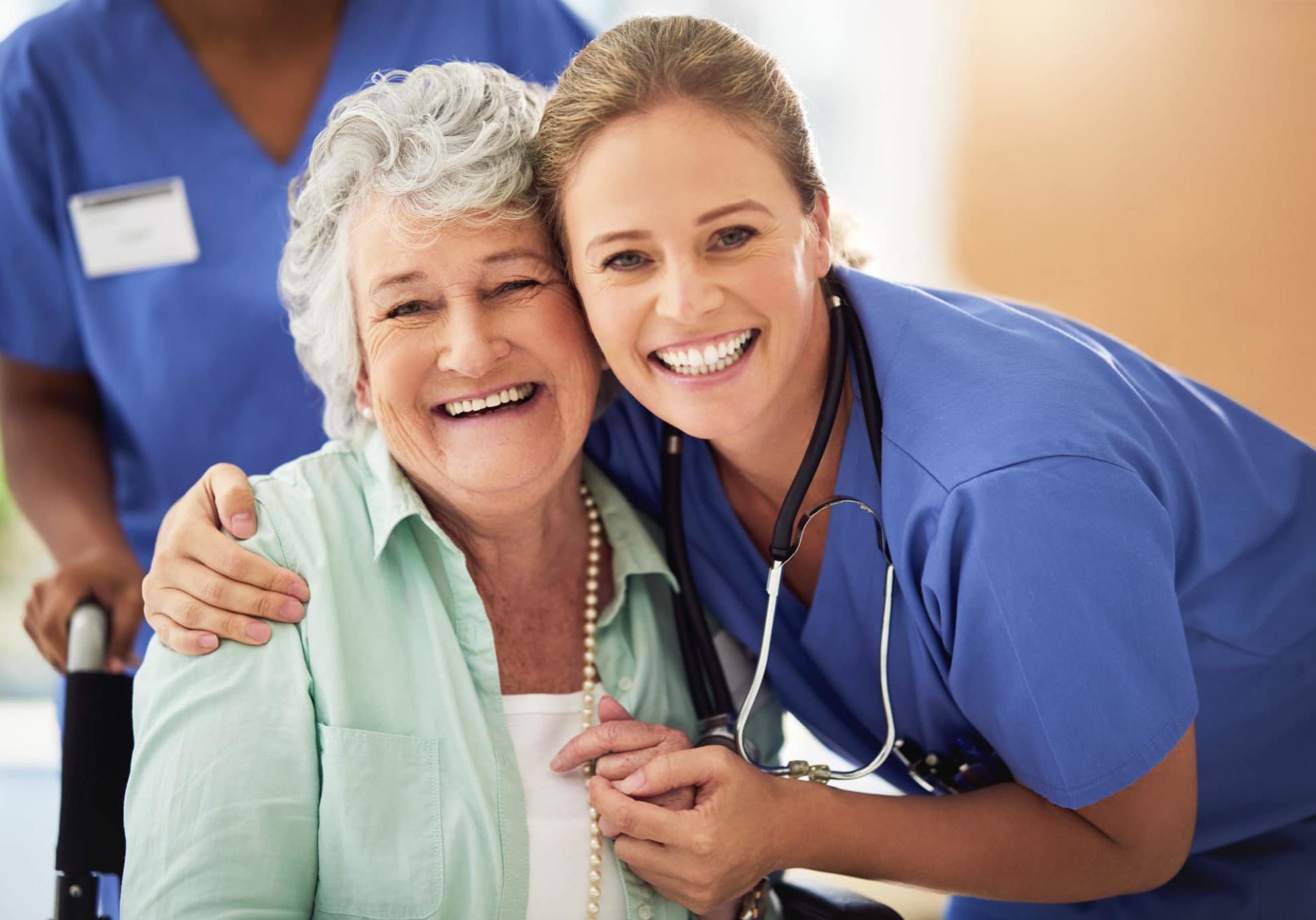 Portrait of a smiling nurse with her senior patient in a hospital